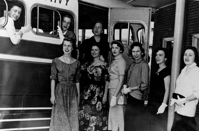 A group of ladies stylishly boarding a bus, c. 1950s