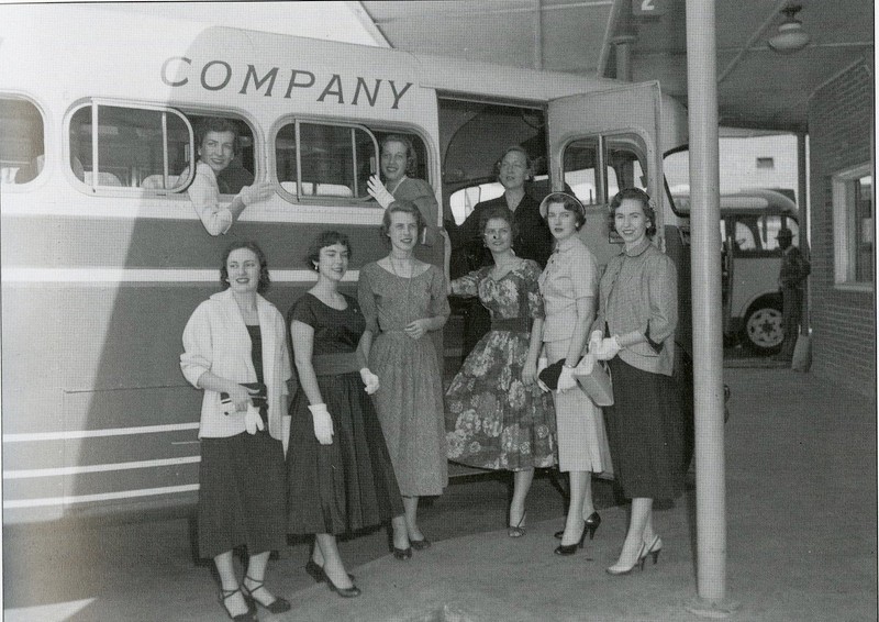Some ladies posing while boarding their bus, c. 1950s.