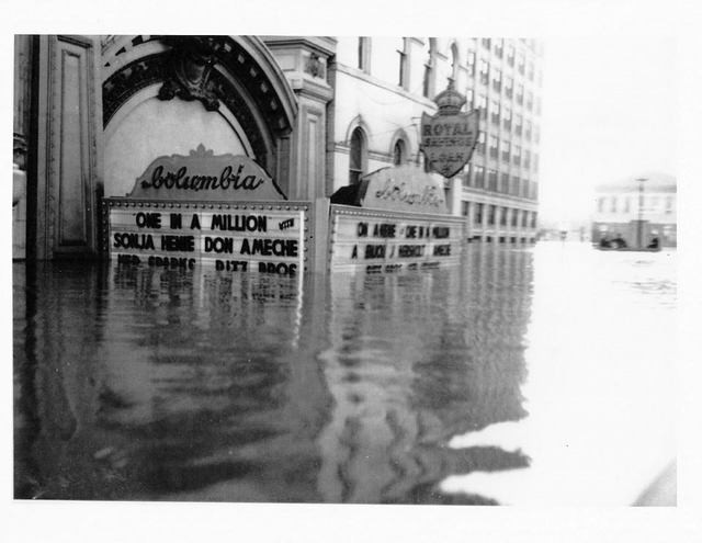 The movie theater underwater in the Great Flood of 1937, one of several natural disasters that damaged but failed to destroy the historic theater. 