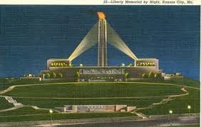 Early postcard depicting the Liberty Memorial Tower lit at night with flame at top