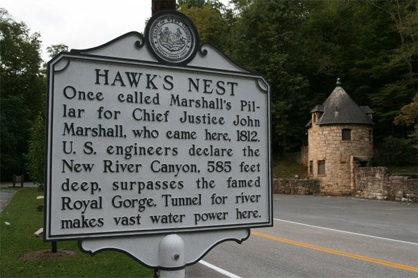 The state historical marker erected in 1937, as Governor Homer Holt took office. Holt was determined to minimize public knowledge of Union Carbide's negligence toward the safety of the Hawks Nest Tunnel workers. Located at the Overlook.