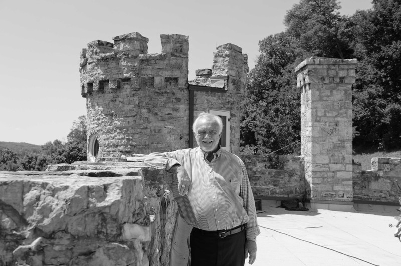 Andrew Gosline, one of the most recent owners, standing on the roof of the castle