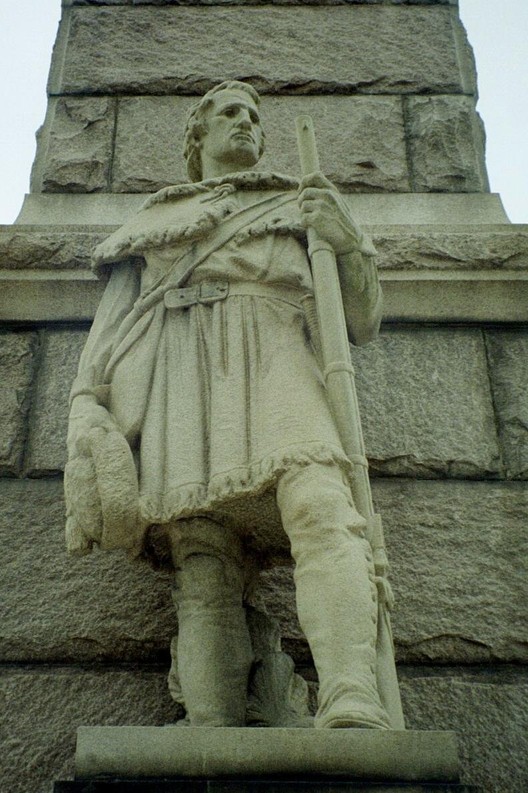 A sculpture at the base of the memorial obelisk depicting a Virginia frontiersman.