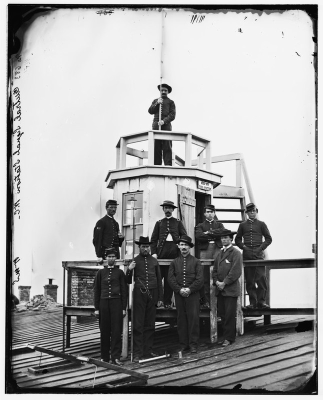  Signal Corps men stand at the Central Signal Station that was constructed atop the Winder Building in 1865.