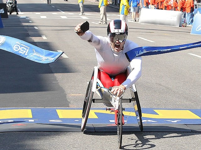 Despite record heat, Josh Cassidy of Canada wins the marathon, breaking the course record. 