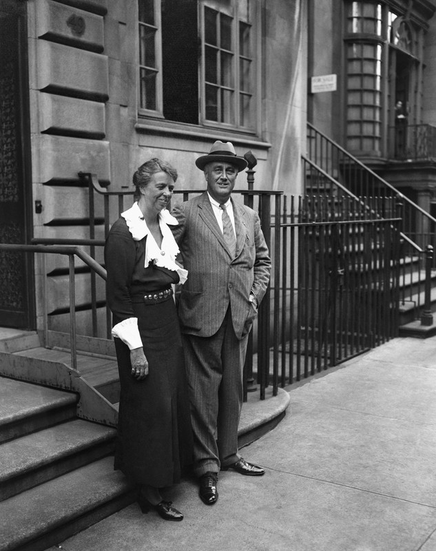 President Franklin D. Roosevelt and first lady Eleanor Roosevelt standing in front of their home located on East 65th St. in New York, 1933