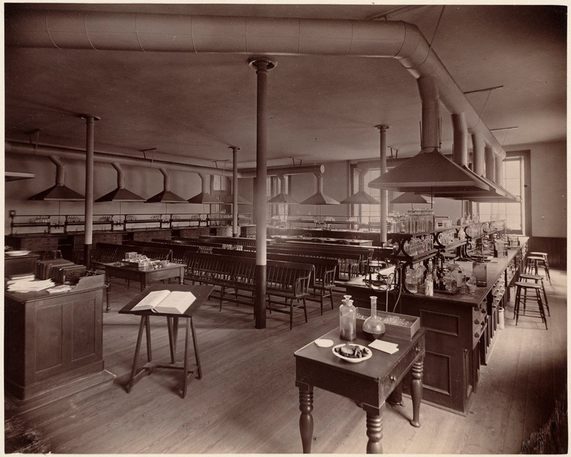 Black & White photo of 19th Century Chemistry Lab classroom with benches and exhaust hoods