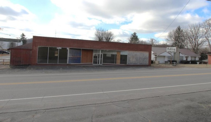 The former home of a turn-of-the century Blacksmith and a mid-century grocer, this building was home to Ashley Furniture for over five decades. From its listing on Old Colony.