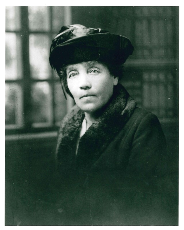 Black and white portrait photo of woman wearing a hat