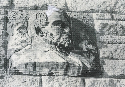 A close-up of the damaged bas-relief sculpture of Oliver Ames Jr.