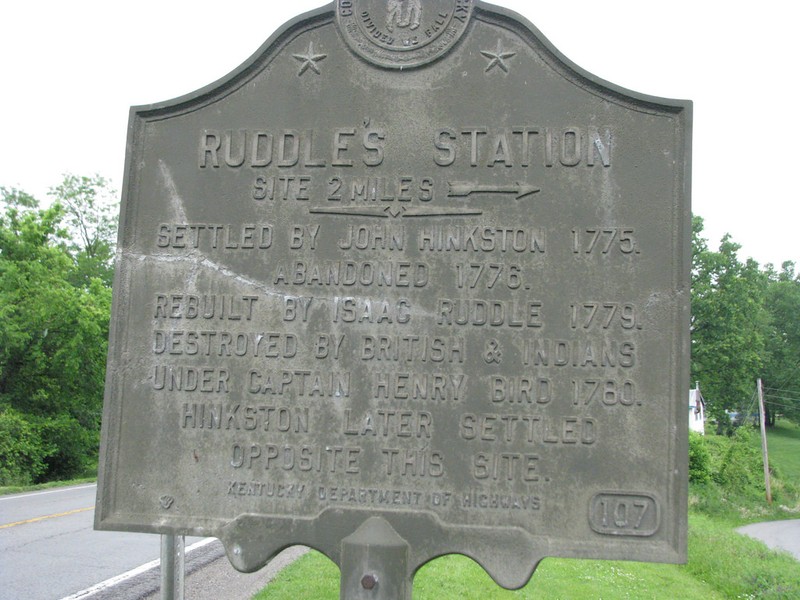 The historical marker for Ruddle's Station which reads "Settled by John Hinkston 1775. Abandoned 1776. Rebuilt by Isaac Ruddle 1779. Destroyed by British and Indians under Captain Henry Bird 1780. Hinkston later settled opposite this site."