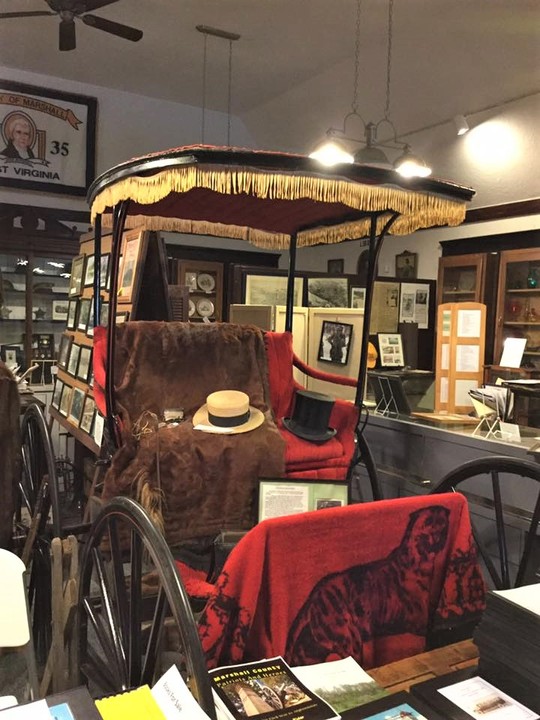 A refurbished carriage greets visitors in the main room.