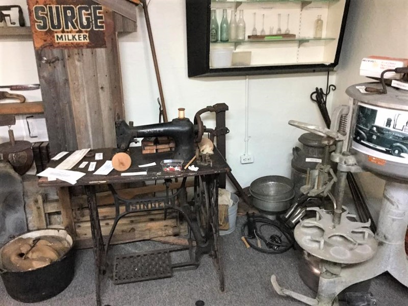 An industrial sewing machine and a bottler used by Gray's Dairy.