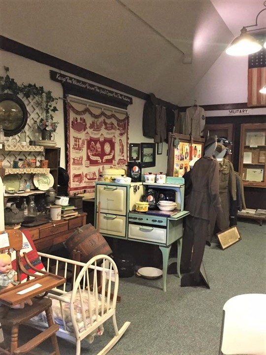 Antiques along with a military display that includes uniforms from various branches and time periods.