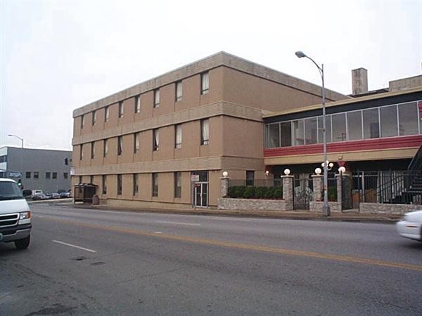 In the 1980s the building's red and white metal paneling was covered with brown stucco. It was later removed during restorations in the early 2000s. Image obtained from Architect Magazine. 