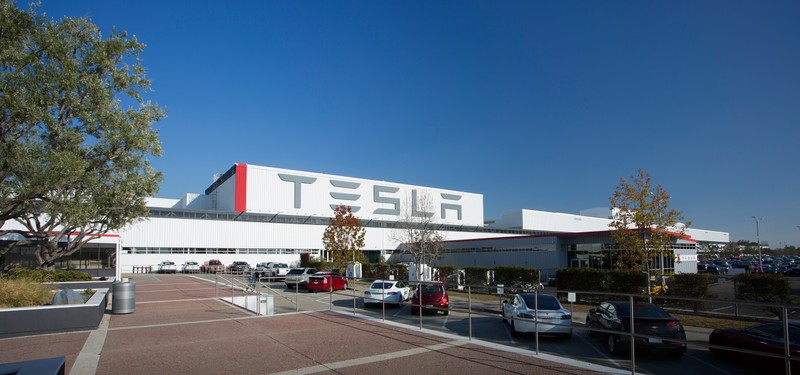 The current facade of Tesla Motors' Fremont factory. All Tesla vehicles are currently made here, though a massive "Gigafactory" was under construction in 2018 in Reno, NV, with plans to open overseas factories in the coming years.