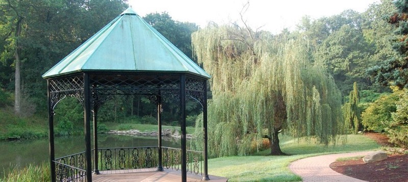 A gazebo sits beside a pond within Mount Airy's Arboretum.
