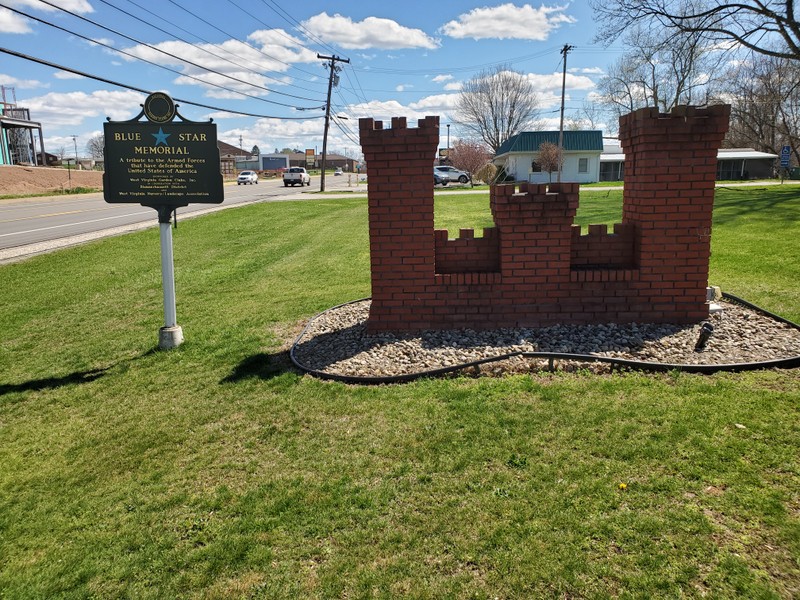 Image of the Blue Star Memorial Marker accompanied by the Army Engineer castle in the front lawn of the Parkersburg Armory