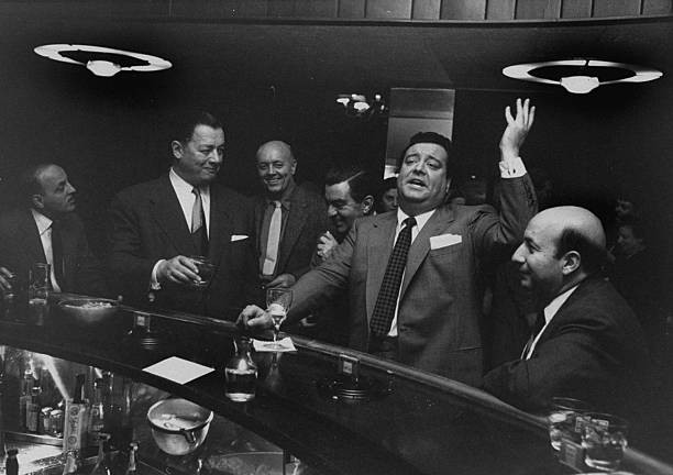 Restaurateur Toots Shor with actor and comedian Jackie Gleason at Shor's infamous "round bar"
