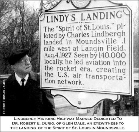 An eyewitness to the landing stands next to the marker representing the location. (Photo courtesy of Thomas James)