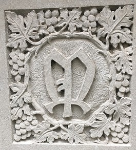 Seal of the Mortley Press, Ltd., London, England, with the design representing the rich borders and bookplates of this house. Located in the atrium at the front entrance to Wise Library.