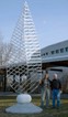 Artist Johnathan Cox beside the Arts Center's first permanent outdoor sculpture, The Discovery IV.