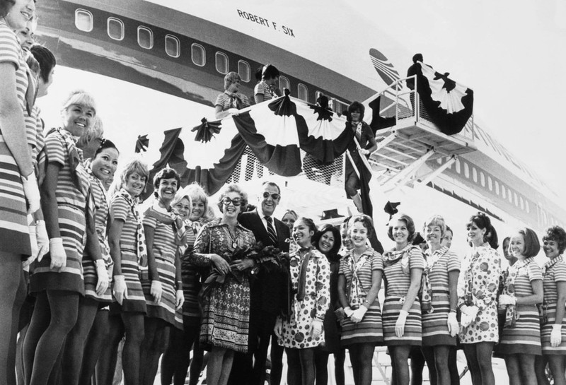 Robert F. Six with his wife, actress Audrey Meadows, and Continental Airlines flight attendants at the dedication of Continental's Boeing 747 named after Six, 1971