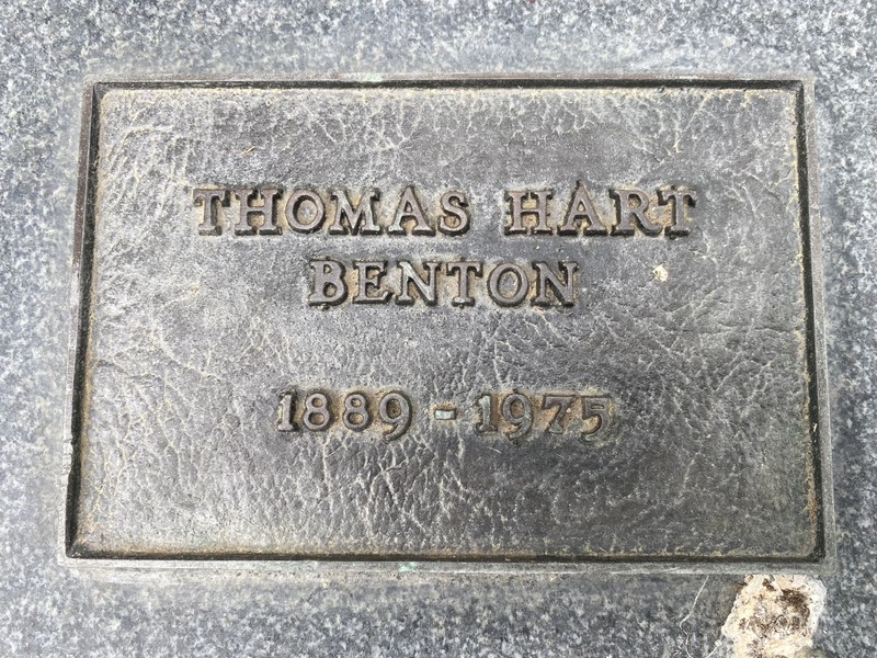 A metal plaque on a stone base.