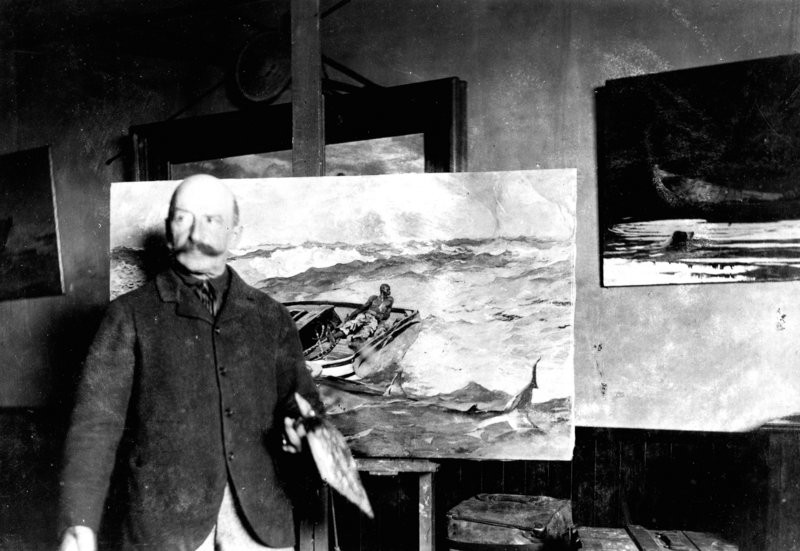 Winslow Homer standing in front of one of his paintings. 