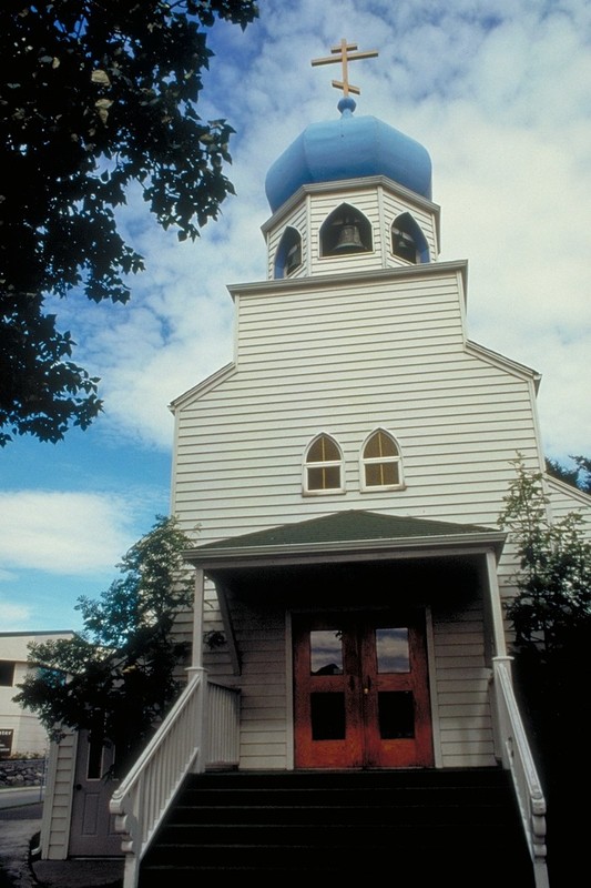 One of the church's distinctive blue domes rises towards the blue sky in this photo of the Holy Resurrection church in Kodiak.