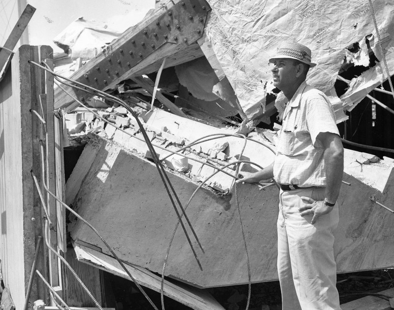 A man looking at the collapse of the main support beams, August 1962.  EKU Photograph Collection.