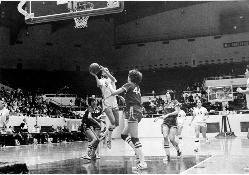 The women's basketball team playing a game in the Alumni Coliseum, ca. 1976.