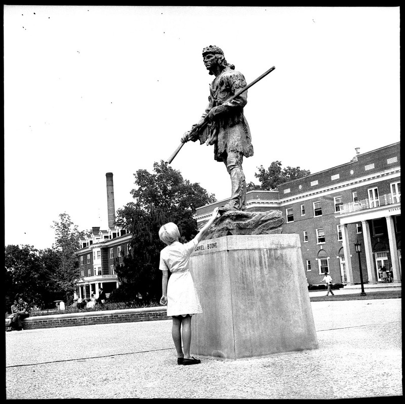 Rubbing the Daniel Boone statue's toe for good luck, 1967. EKU Negative Collection.
