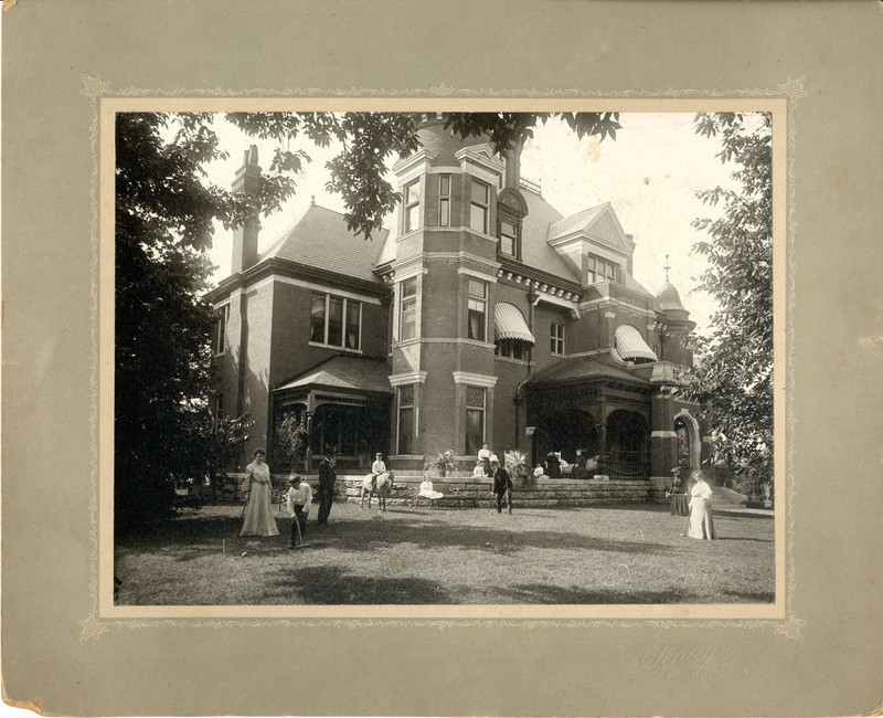 Unidentified people outside of house. Watts Family Papers.