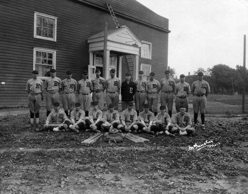 The 1925 baseball team in front of the Temporary Gymnasium, fondly referred to as the "Barn."