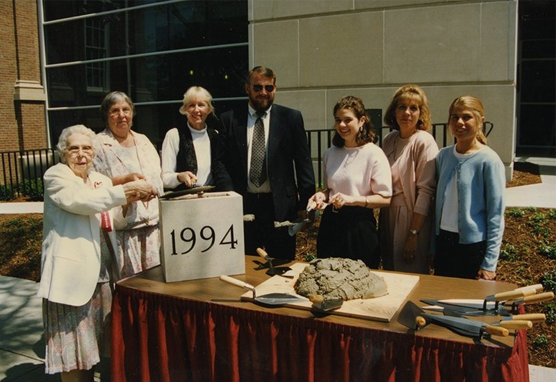 Hazel Little and other unidentified people spreading mortor on the cornerstone at the dedication of the Thomas and Hazel Little addition of the Crabbe Library, 1996.  EKU Photo Collection.