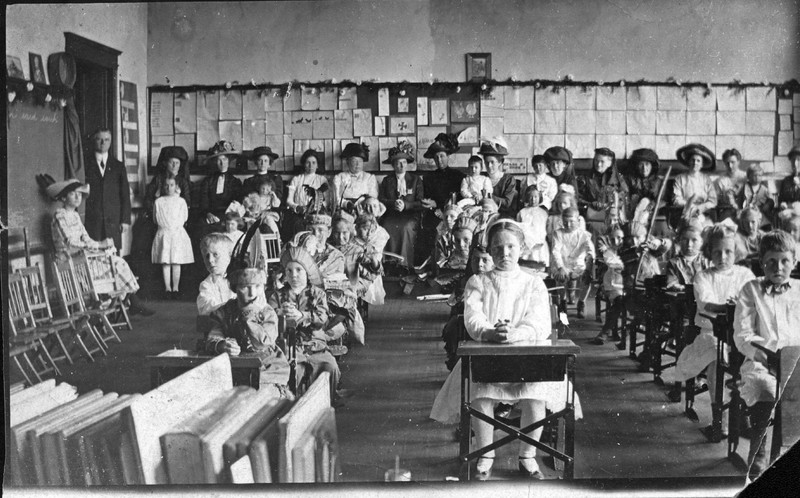 John Grant Crabbe (in doorway) and a class of students from Model Training School in a classroom in the Roark Building, ca. 1915.  EKU Photograph Collection.