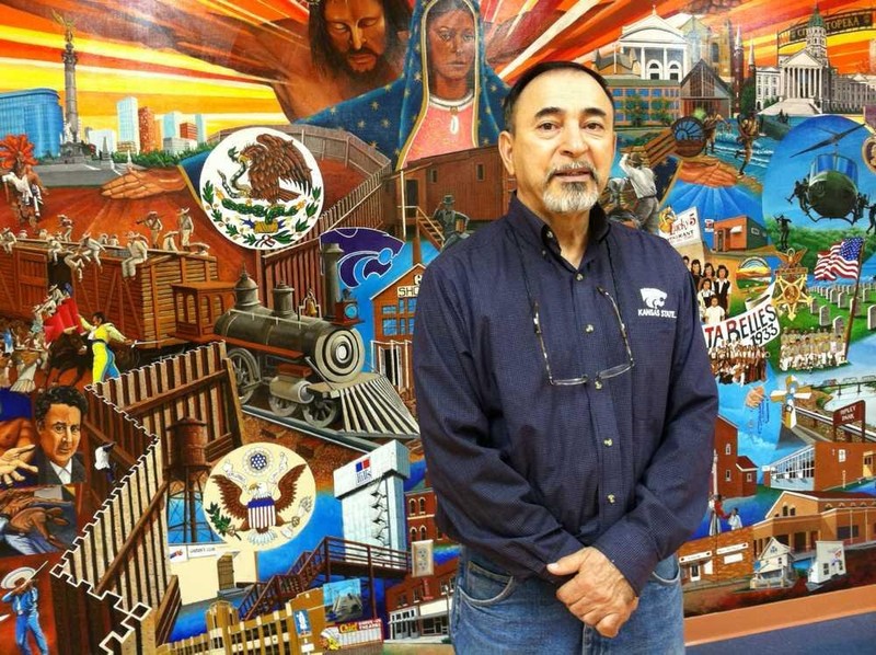 Topeka Native Andy Valdivia stands in front of the large, colorful mural he painted in the basement of the Marlo Cuevas-Balandran Activity Center, 216 N.E Banner. The mural, titled "Our History", depicts the importance of Mexican American heritage.