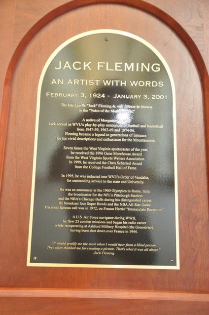 A plaque displayed at the Fleming Corner, honoring the famous announcer "an artist with words."