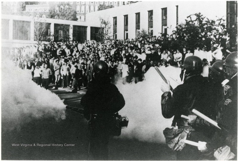 The biggest WVU student protest in the Vietnam era took place in front of the Mountainlair in May 1970, shortly after the bombing of Cambodia and Kent State shootings. Here, the National Guard sprays the raucous crowd with teargas. WVU Libraries.