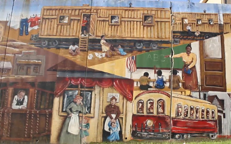 A mural in Argentine depicts Mexican railroad workers living in the boxcars that brought them to Argentine