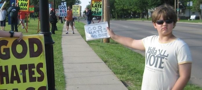 The picture of Josef Miles holding up a "God Hates No One" sign.