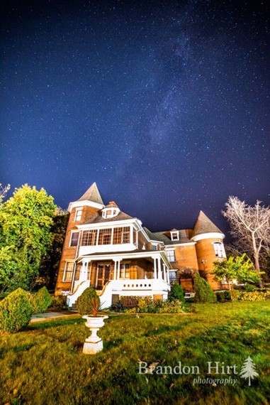 The A.W. Buck House under a night sky.