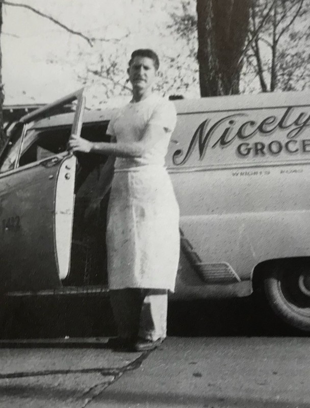 Nicely Butcher Otha "Junoir" Regan stands beside delivery truck