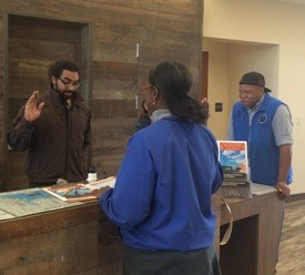 A visitor taking the Junior Ranger pledge with a park ranger at the Harriet Tubman Underground Railroad Visitor Center. 