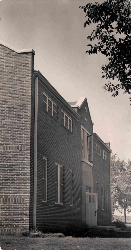 Photo of the Roosevelt County Museum. Front door and upstairs window are open.