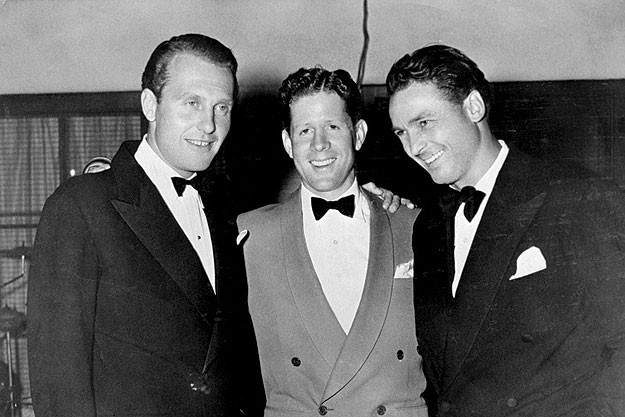 The two founders of the Racquet Club, actors Ralph Bellamy (right) and Charlie Farrell (left), with singer, actor, and radio host Rudy Vallee, attend the opening of the Racquet Club in 1934. 