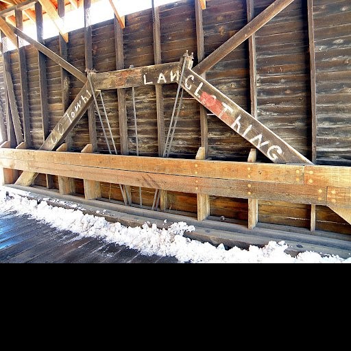 Interior of the bridge. A queenpost truss with metal tension rod connector is visible