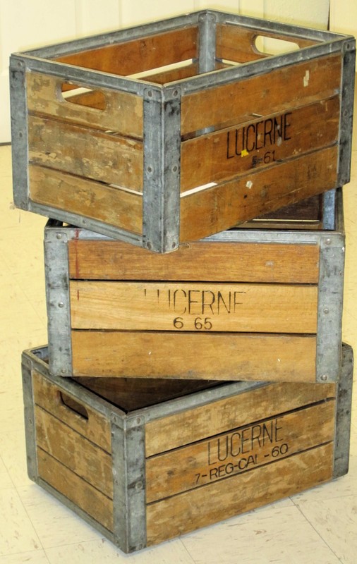 Three stacked wooden Lucerne milk crates from Safeway grocery