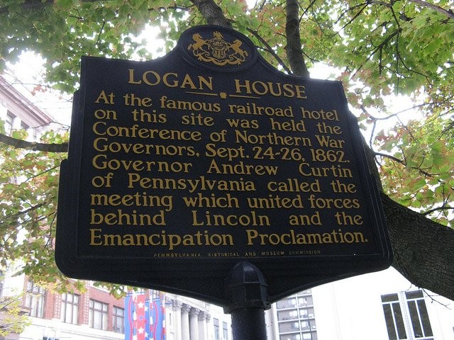 The Logan House marker. Unfortunately, the marker is between a parking garage wall and a USPS chain link fence.